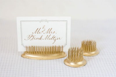 These gold placecard holders would be a perfect tabletop decoration for a dinner party. (100layercake.com) These gold placecard holders would be a perfect tabletop decoration for a dinner party. (100layercake.com)