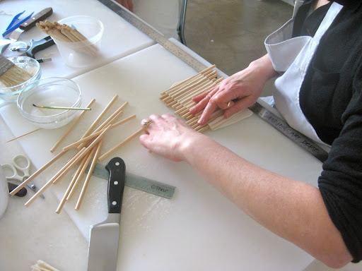 Step 2: Carefully and strategically remove the wooden sticks one by one.