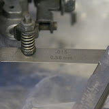 After installing the new accelerator pump diaphragm, I set the travel of the pump actuator. Set the carb to Wide Open Throttle, push the pump arm to full on, and set the screw so that there is .015 clearance. This prevents you from tearing the diaphragm at WOT.