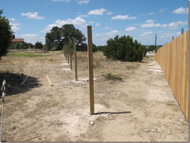 Riding arena to the left of wooden posts, pasture to right Riding arena to the left of wooden posts, pasture to right