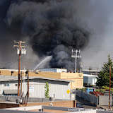 Around 3pm today, a large industrial fire broke out in the industrial area near Fruitridge and Power Inn. Engines, Trucks, Battalion Chiefs, Ambulances and other support apparatus responded from all over Sacramento to aid in containing the blaze.
Upon our arrival in the area, deep black towering smoke clouds belched from the area. Fire crews went into a defensive containment mode by laying large supply water lines and deluging the blaze with arial fire apparatus. The inferno was contained in short order and traffic moved freely again down Power Inn. With the high winds that were present and the wind the fire makes on it's own, this fire could have been a nightmare. Thanks to rapid responding and well trained fire crews, the conflagration was managed, contained and extinguished without further complications. Industrial Fire, Pacific Corrugated Pipe Company