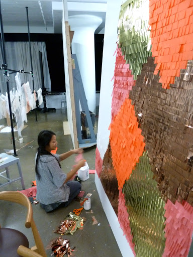 Julie applied fringe in layers to create the photo-booth backdrop the night before the shoot.