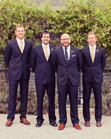 This groom picked out the navy J.Crew suits and khaki ties sported by the groomsmen. This groom picked out the navy J.Crew suits and khaki ties sported by the groomsmen.