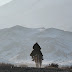 Kazakh camel herder on the plane above Dabancheng