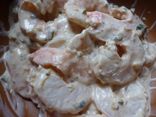 Shrimp is tossed with some of the remoulade sauce.