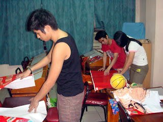 Students wrap the toys to be distributed the next day.