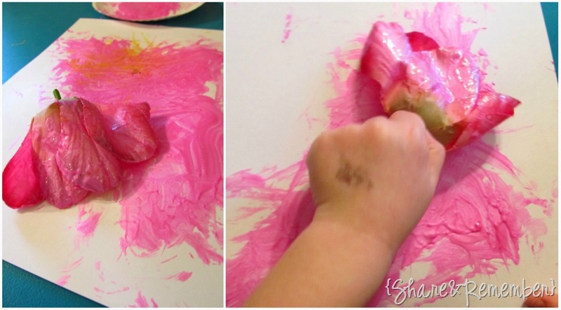 painting with silk flowers in preschool paint