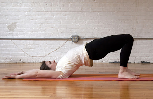 2. Breathe in to lift the hips and arms overhead