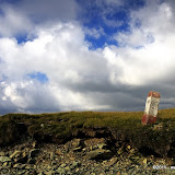 Red and White Milestone very high in the mountains marking the trans-alpin road in Romania