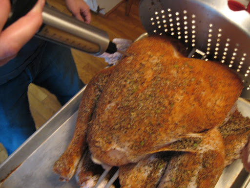 The bird on the rack being injected with flavorings.