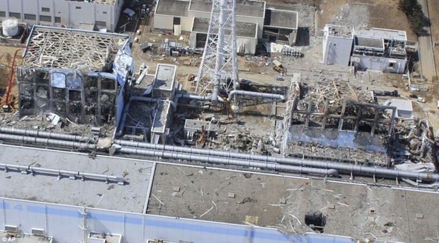Demolished: An aerial view of the plant taken on March 24 shows Unit 4 and Unit 3 of the Fukushima Dai-ichi nuclear power plant in Okumamachi. A red crane far left shows the valiant efforts of the 'Fukushima 50'. dailymail.co.uk