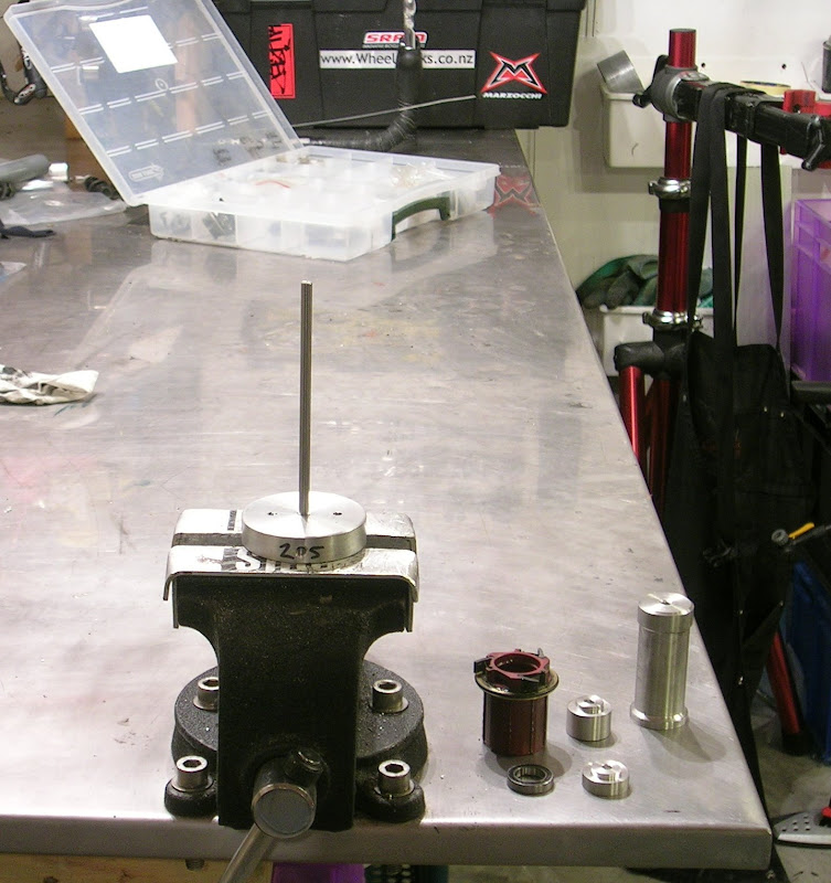 The press tool's base clamped in the vise