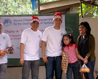 MCCID Quezon Trainor Edmond Guzman pose with a child recipient.