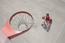 5001331-two-kids-playing-basket-ball-in-the-summer