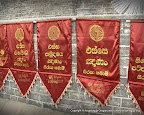 Hanging Ganana Kodi (Flags) around Pesa Walalu (outer rings of Ruwanweliseya stupa)