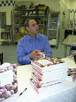 John, busy signing and greeting guests.
