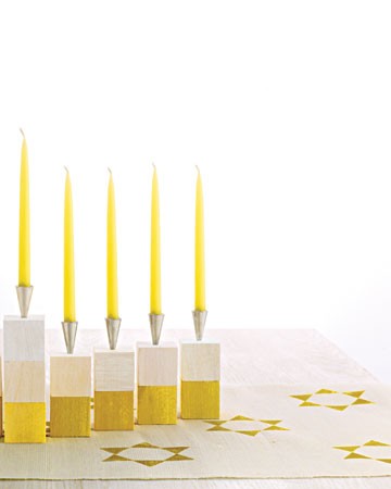 Made with wooden blocks, cheery paint colors, and shiny candleholders (actually pastry tips), this simple menorah can be constructed by kids and parents together. For added flair, stamp a star pattern onto fabric to create a runner. Made with wooden blocks, cheery paint colors, and shiny candleholders (actually pastry tips), this simple menorah can be constructed by kids and parents together. For added flair, stamp a star pattern onto fabric to create a runner.