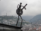 One of the little metal musicians, with the statue with the big angel on it in the background.