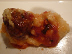 Soft, creamy polenta topped with tender meatballs.