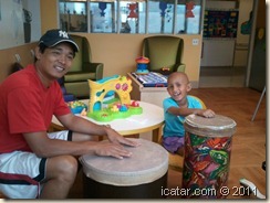 Playing on the bongos in the playroom.