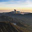 Bromo shoots ash into the air, surrounded by the relative calm of mist filled Tenggara valleys