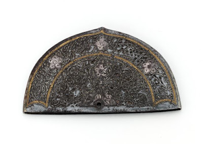 A comb back | Origin:  Iran | Period: 17th-18th century | Details:  Not Available | Type: Iron | Size: H: 6.1  W: 10.9  cm | Museum Code: F1940.5 | Photograph and description taken from Freer and the Sackler (Smithsonian) Museums.