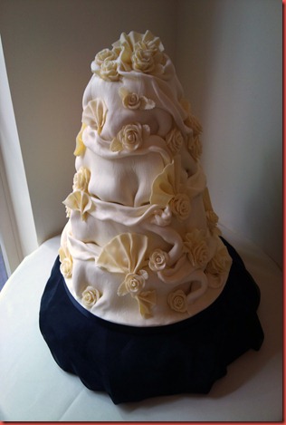 4 tier chocolate ruffle and rose and fans cake