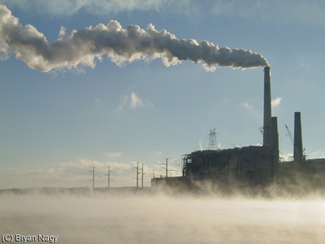 Coal-fired power plant at Mount Storm, West Virginia, November 2000. The artificial lake was built to be the source of cooling water for the coal power plant in the background, and because the water is about 80 degrees all the time, it attracts a lot of divers during the cold season. wet suits are still necessary, because the air is still freezing. Bryan Nagy