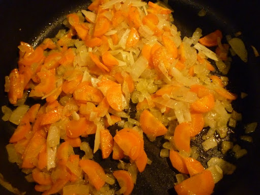 Onions, carrots, and garlic cook until tender and sweet.