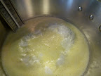 Ricotta curds starting to bubble up.
