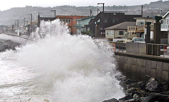 Waves pound a wall in Pacifica, California, during a January 2010 storm. A recent survey found that most Americans were no longer willing to accept a hands-off approach to continued coastal development that will get battered repeatedly by rising seas as the climate changes. Photo: Paul Sakuma / Associated Press