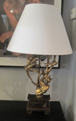 Love the bird on the branch in bronze.