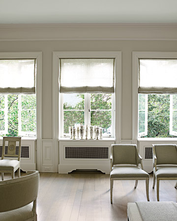 Shades are partially drawn in this gray sitting room. Shades are partially drawn in this gray sitting room.
