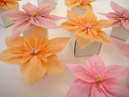 Glue flowers to the top of small favor boxes. We used two different sizes to create variation in height.