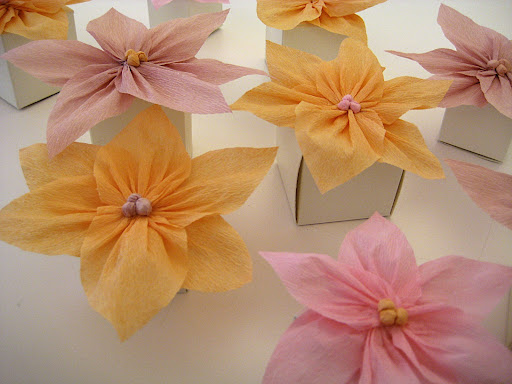 Glue flowers to the top of small favor boxes. We used two different sizes to create variation in height.