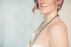 A chain necklace with powder-blue and nude shells was a fitting accessory. A chain necklace with powder-blue and nude shells was a fitting accessory.