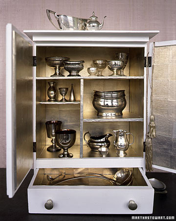 An exquisite silver leafed cabinet makes a beautiful backdrop for a silver collection. (marthastewart.com) An exquisite silver leafed cabinet makes a beautiful backdrop for a silver collection. (marthastewart.com)