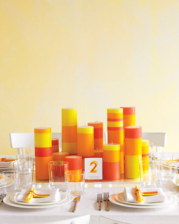 A big, vibrant pop of color in the form of bright candles you design yourself casts a warm glow over an otherwise clean, minimalist table. (marthastewartweddings.com) A big, vibrant pop of color in the form of bright candles you design yourself casts a warm glow over an otherwise clean, minimalist table. (marthastewartweddings.com)