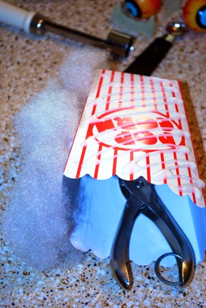 Placing stuffing on box to make it furry.jpg Placing stuffing on box to make it furry