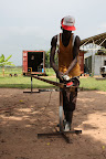 Workman preparing purlins for painting