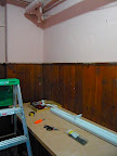 My potting bench is in a store room in the basement of my building. The bench top is an old solid core door attached to cast off kitchen cabinets. The light I use is a 48