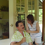 Carrie cuts her dads hair on the back deck.