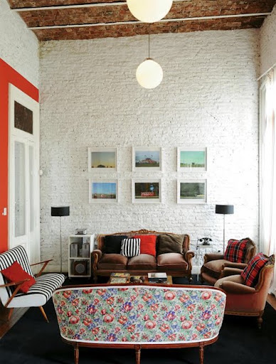 Plaid pillows are thrown into a bright and colorful room.