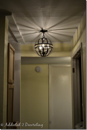 metal orb light fixture created with two hanging garden baskets