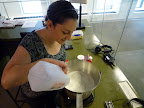 Monty pouring milk into large pot.