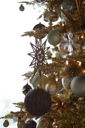 Instead of going with a monochromatic palette and uniform shapes, I mixed things up with ornaments in different shapes and shades.