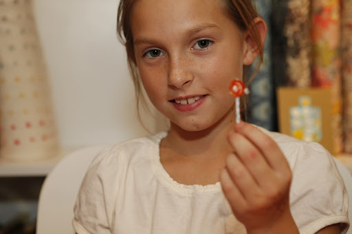 Another guest shows off the button barrette she made.