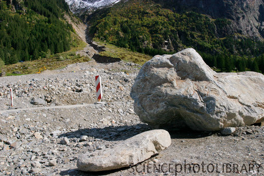 Landslide blocking a road at the Grimsel Pass near the village of Guttannen, Switzerland, after heavy rains in August 2005. The rains caused the Rotlaui river (seen at upper left) to become greatly engorged and burst its banks. They also caused the nearby Aare river to be diverted, flooding parts of Guttannen. MICHAEL SZOENYI / SCIENCE PHOTO LIBRARY