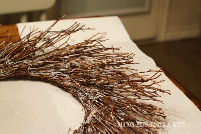 Use Folk Art Chunky Glitter paint to add glitter to the wreath. World Market inspired wreath. A fun twist on a Christmas wreath. Make a winter wreath that will last all season long and well past. This cute grapevine wreath is adorned with a tiny bird, pinecones, greenery and pom poms. You won't believe how cheap and easy this was to make! And so simple! #Christmas #winter #holiday #wreath #nature #knockoff Use Folk Art Chunky Glitter paint to add glitter to the wreath. World Market inspired wreath. A fun twist on a Christmas wreath. Make a winter wreath that will last all season long and well past. This cute grapevine wreath is adorned with a tiny bird, pinecones, greenery and pom poms. You won't believe how cheap and easy this was to make! And so simple! #Christmas #winter #holiday #wreath #nature #knockoff