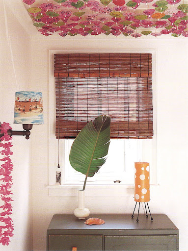 A Hawaiian-themed guest bedroom embellished with vintage home accessories from Honolulu - the paper cocktail umbrellas hanging upside-down from the ceiling are quite imaginative.